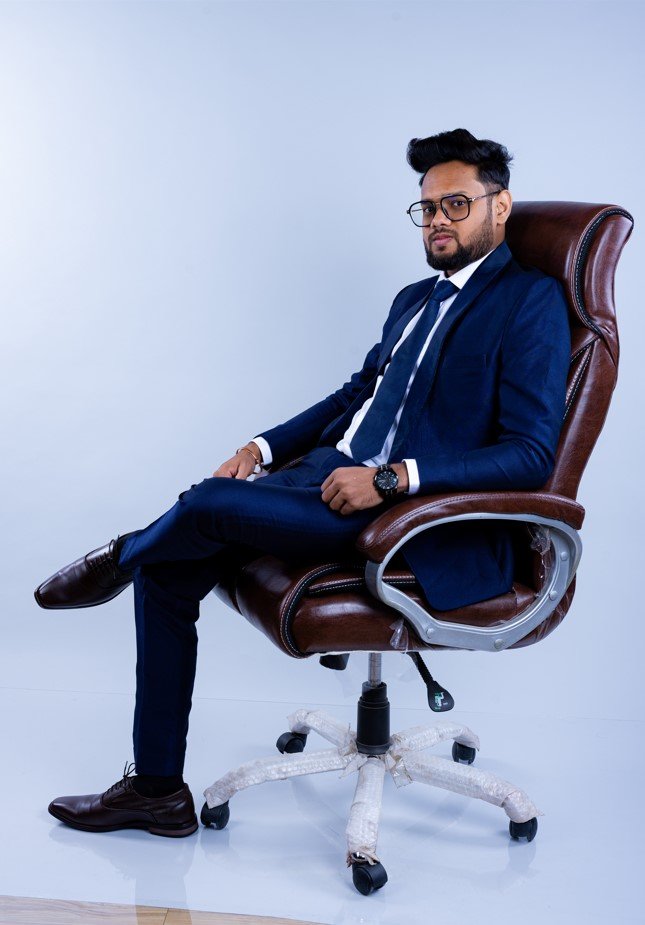 Naman Nandurkar, Founder and CEO of Octmi, seated in an office chair wearing a formal suit