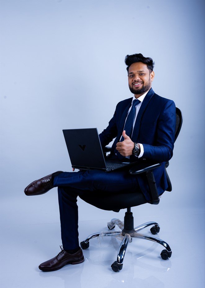 Naman Nandurkar, tech founder and CEO of Octmi, working on a laptop during a studio shoot